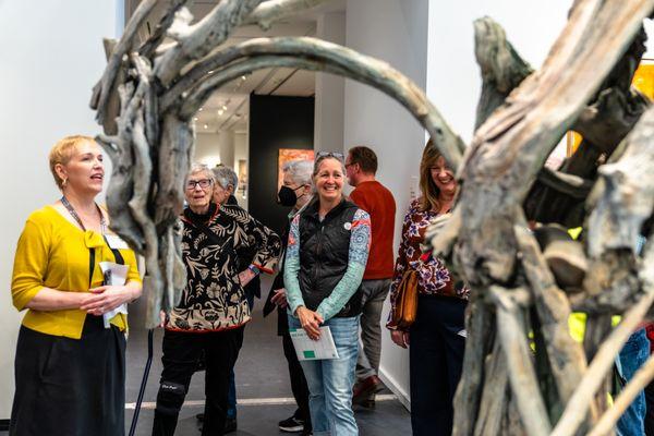 Museum visitors attend a staff-led tour in the collection galleries.