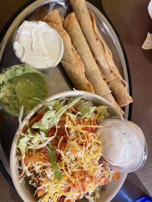 Rolled shredded beef taquitos with a side salad