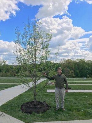 Kevin standing proudly with a Dogwood Tree that we donated to the Archdiocese