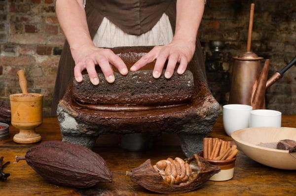 One of the interpreters demonstrating how chocolate was made in colonial times.