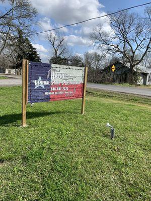 Haynie's sign outside with a picnic table beside it