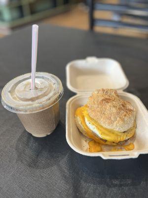 Breakfast biscuit with turkey sausage and an iced au lait.