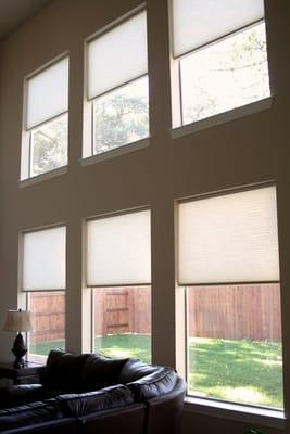 Motorized cellular shades are great for high windows.  You can control them with a remote and even synchronize them!