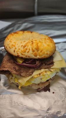 Steak egg and cheese served on Asiago bagel grilled onions and peppers