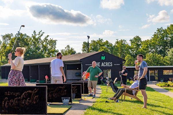 Driving range visitors enjoying the scenery, a bucket of balls, and a cold beer or two.