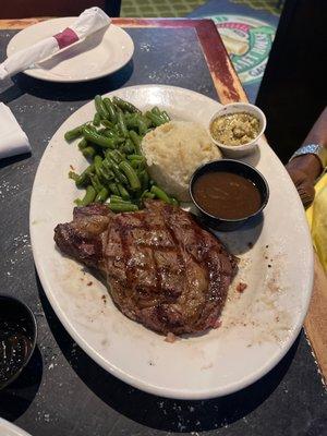 12oz Ribeye steak well done with potatoes, gravy and string beans