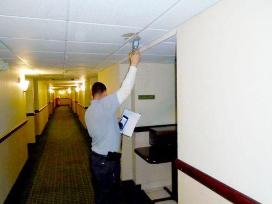 One of our technicians measuring the moisture in the ceiling