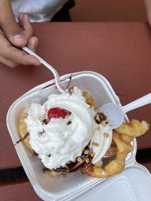 Funnel sundae with ice cream, chocolate, peanuts, & cherry on top