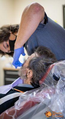 A patient getting fitted for his new dentures.