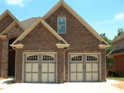 carriage house doors that are fully insulated and has a Desert tan almond color mix. Great combination to the home!