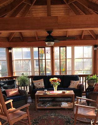 interior view of a five sided hip roof with Sunspace windows and mahogany floors.