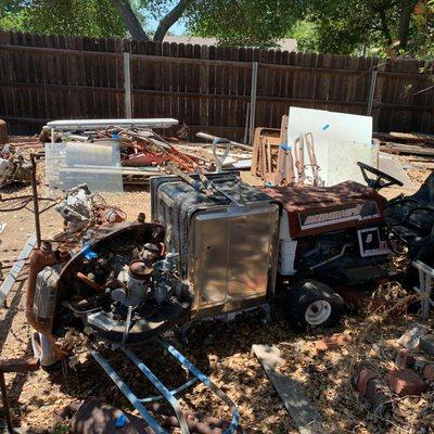 Property Cleanup in Granite Bay before the Removal and disposal of Riding Lawnmowers, water heaters and 30 years of mess!