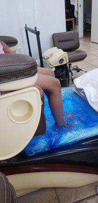 My littlr girl soaking her feet during the foot spa pedicure.