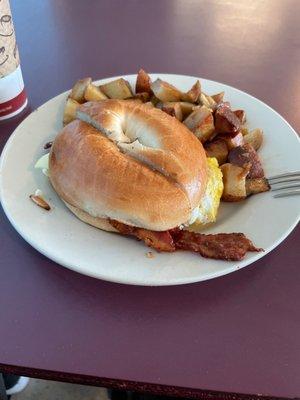 Bacon, egg n' cheese on a plain bagel w/ homefries