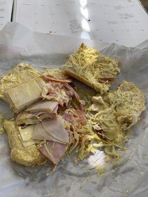 Sandwich so smothered in mustard it was basically a mustard sandwich with: salty, pressed, low quality turkey and ham meats.