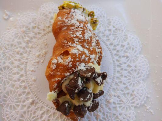 Fresh cannoli.  Delicious. Half chocolate chips and half pistachios.