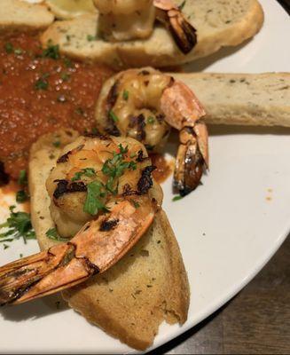 Grilled shrimp marinated in white wine, lemon juice, olive oil, and herbs