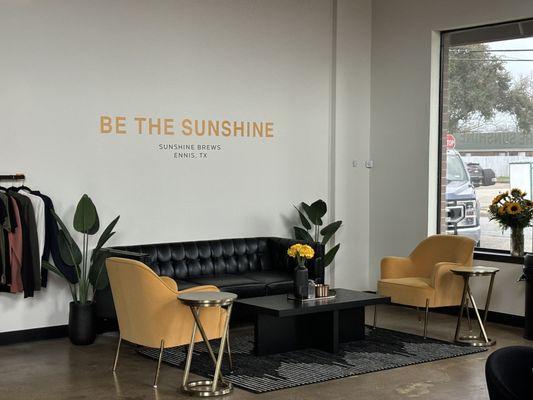 Charming seating area. Love the "Be the Sunshine" sign.