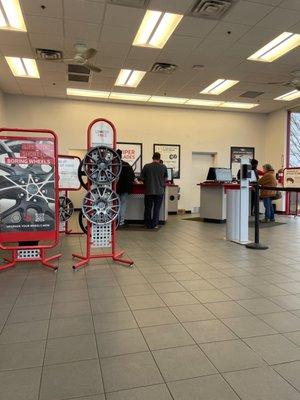 Two employees servicing other customers with their tire orders