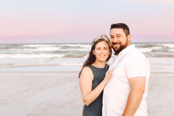 A couple poses for a sunset photoshoot on the beach in Corpus Christi, Texas.