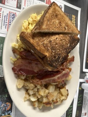 3 scrambled eggs 3 slices of bacon (little crisp) Burnt whole wheat toast Home fries that weren't crispy