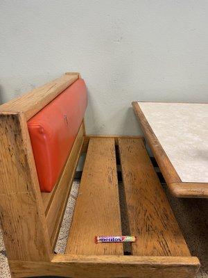 Candy depicted for scale to highlight the narrow opening of this stationary bench and table.