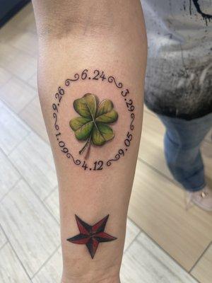 4-leaf clover tattoo with kids birthdays surrounding it.