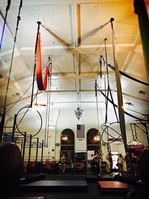 Inside our home gym showing off several aerial apparatus rig points and 21' ceilings, the highest of any aerial gym in phoenix!