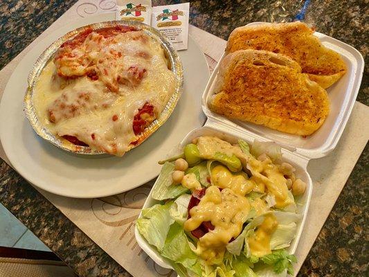 Chicken Parm dinner with salad and garlic toast