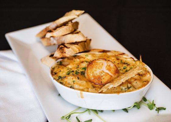 Baked Seafood Artichoke Dip with roasted artichoke, spinach, Parmigiano-Reggiano, herbs, shrimp, langostino, and scallops