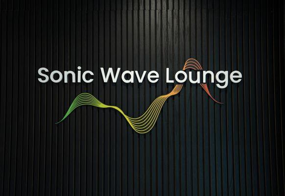 Stylish Sonic Wave Lounge logo on a wall panel.