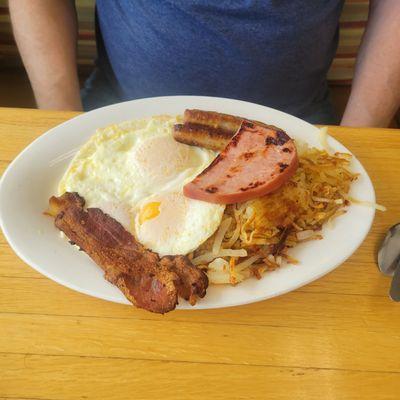 Can't remember what this is called but it's the big breakfast. 3 over easy eggs, a slice of ham. 2 bacon. 2 sausage, hashbrowns and toast.