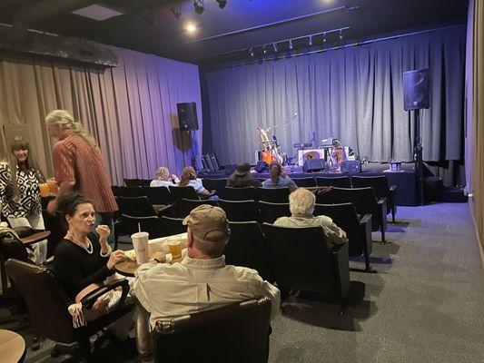 The theater offered traditional theater-style seating and small tables.