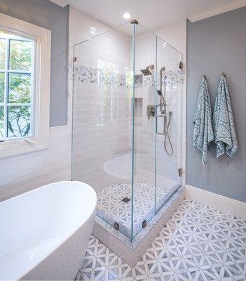 Enlarged shower. Tile is marble mosaic on floor and subway on walls.