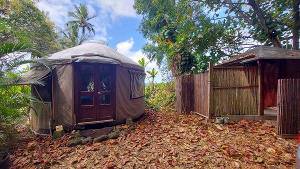 The yurt and outdoor shower in a tropical paradise