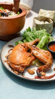 Somtum Gai Yang - Chicken grilled with spices. Served with papaya salad, Thai sweet and sour sauce, and sticky rice