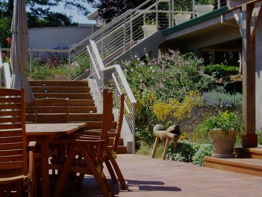 This corner is brought to life with plants.  The steps and railing allow for encourage appreciation of the surroundings.