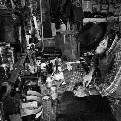 Larry, the owner, working on a bag.