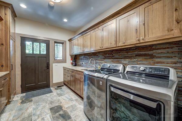 Who says a laundry room has to be dull and boring? We designed this space to feel like nature with tons of storage and easy care finishes.