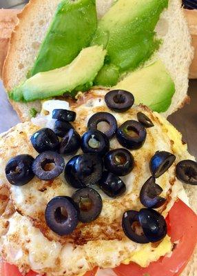 Midtown with fried eggs, cream cheese, avocado, tomatoes and black olive on Kaiser roll #breakfastallday