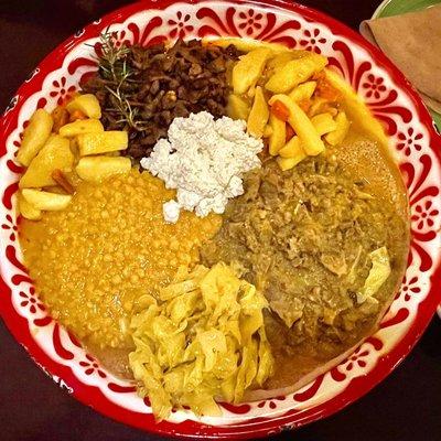 (Top - clockwise) Beef Tibs, Potatoes and carrots stew, Lamb (Alicha) curry, cabbage stew, Yellow lentils-peas stew with turmeric