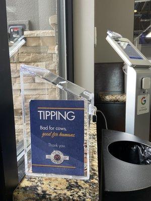 In the waiting area: a tip box and the thing behind it where you can tip using a card