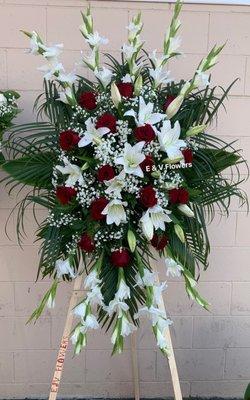 Standing spray. Red roses, white lilies and flowers.