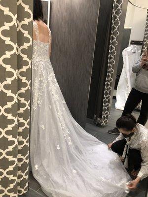 Wedding dress fitting to add bustles so bride can easily move around or for dancing.