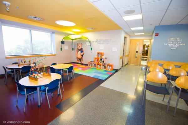 Medical clinic children's waiting area with reading nook.