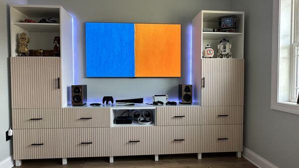 LG Gallery 65 inch, Sonos Faber Lumia bookshelf pair, Sonos Amp and sub mini hiding on other side.