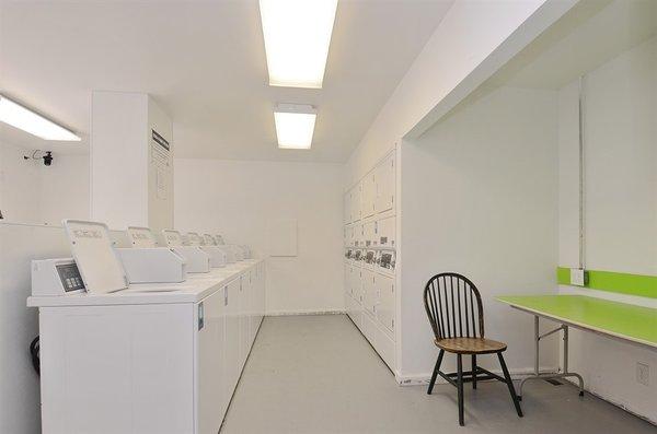 Common use laundry room with several high-capacity washers and dryers