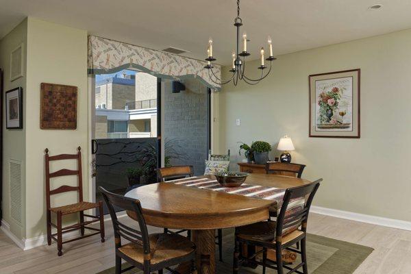 The adjacent Dining Area in this condo features a paint color one shade lighter than the Living Room, and another shaped valance.