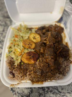 Oxtails, Rice and Peas, with Jerk Chicken gravy, and Cabbage.