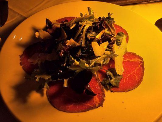 Carpaccio: thin slices of filet mignon, mixed greens, shaved parmesan cheese, olive oil